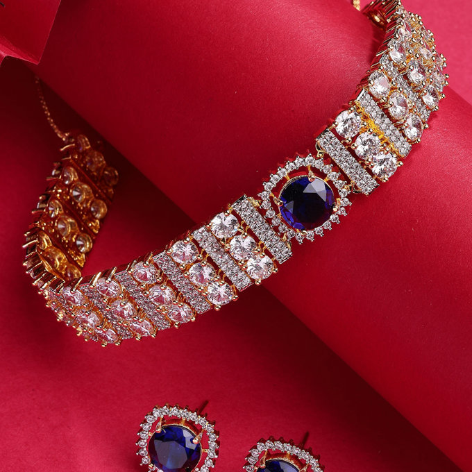 Sukkhi Lavish Gold Plated Cubic Zirconia Studded Blue Brass Choker Necklace with Studs Earrings Jewellery Set for Women