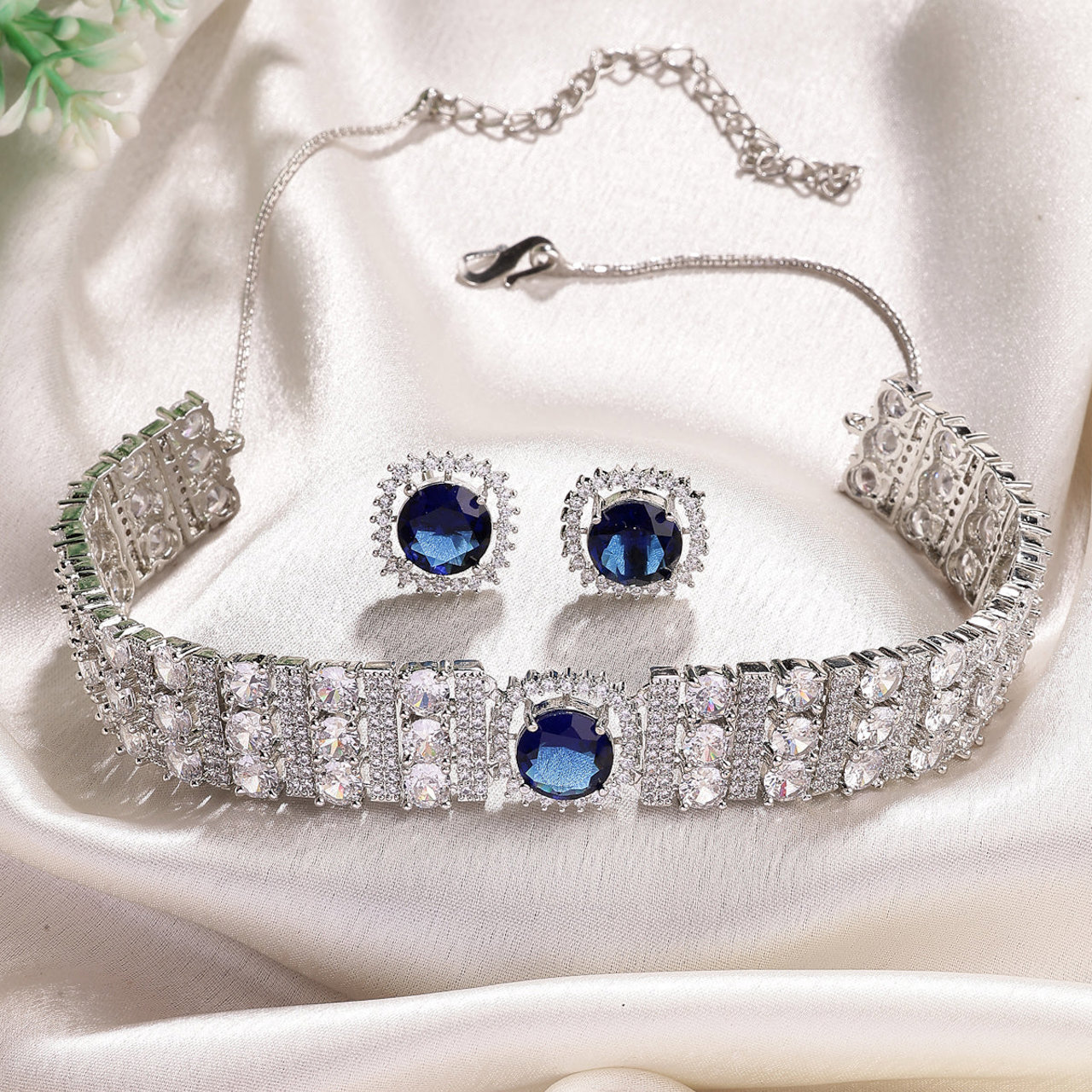 Sukkhi Iconic Blue Stylish Design Rhodium Plated Cubic Zirconia Studded Brass Choker Necklace with Studs Earrings Jewellery Set for Women