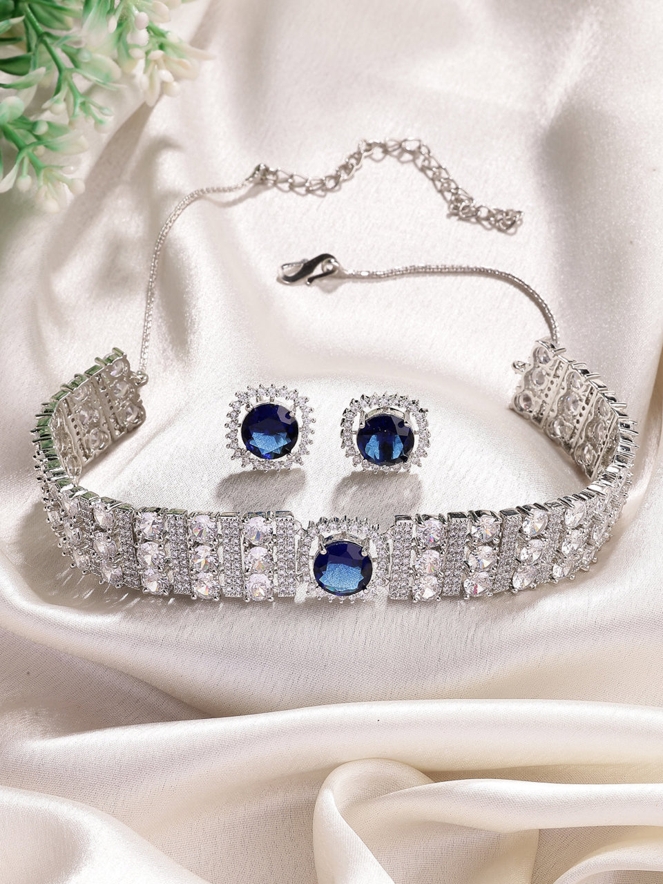 Sukkhi Iconic Blue Stylish Design Rhodium Plated Cubic Zirconia Studded Brass Choker Necklace with Studs Earrings Jewellery Set for Women