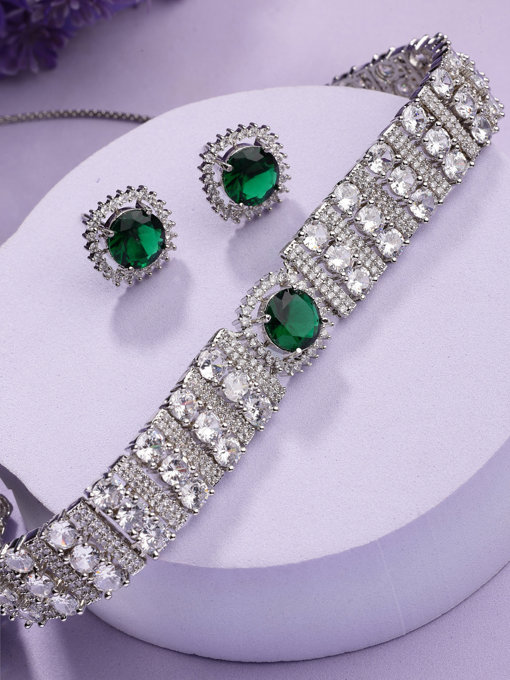 Sukkhi Delicate Fashionable Design Rhodium Plated Cubic Zirconia Studded Emerald Green Brass Choker Necklace with Studs Earrings Jewellery Set for Women