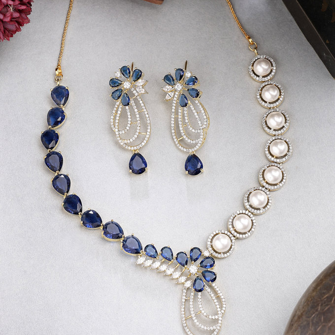 Sukkhi Unique Tear Drop Round Design Gold Plated Cubic Zirconia & Pearl Studded Blue Brass Collar Necklace with Drop Earrings Jewellery Set for Women