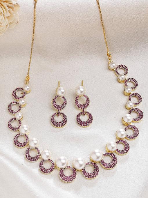 Sukkhi Bewitching Round Design Gold Plated with Cubic Zirconia & Pearl Studded Red Brass Collar Necklace with Drop Earrings Jewellery Set for Women