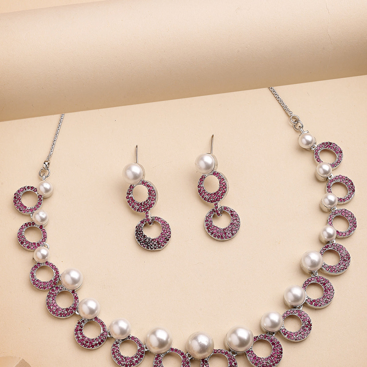 Sukkhi External Stylish Rhodium Plated with Cubic Zirconia & Pearl Studded Red Brass Collar Necklace with Drop Earrings Jewellery Set for Women