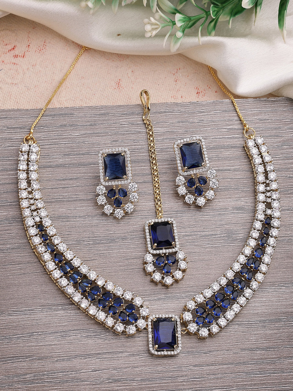 Sukkhi Sparkling Royal Blue Gold Plated with Cubic Zirconia Studded Brass Collar Necklace with Studs Earring & Maangtikka Jewellery Set for Women