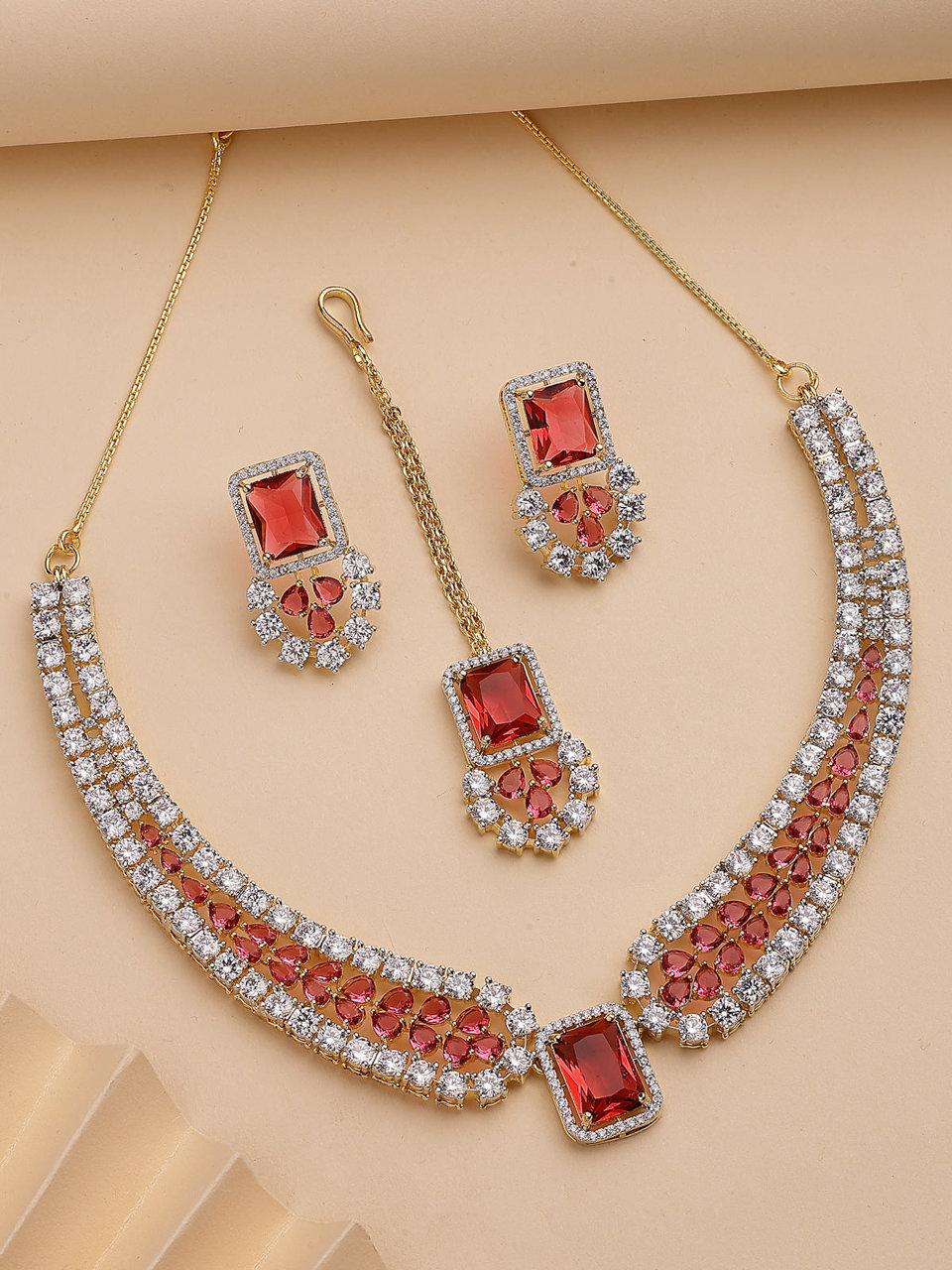 Sukkhi Unique Stylish & Designable Gold Plated Cubic Zirconia Studded Brass Red Collar Necklace with Studs Earring & Maangtikka Jewellery Set for Women