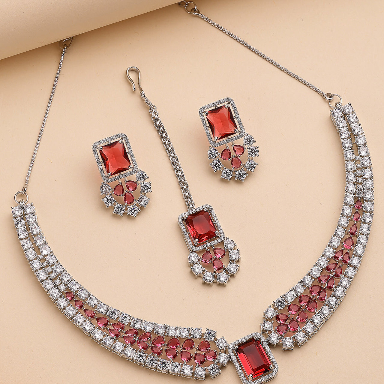 Sukkhi Charming Fashionable Rhodium Plated Red Cubic Zirconia Studded Brass Collar Necklace with Studs Earring & Maangtikka Jewellery Set for Women